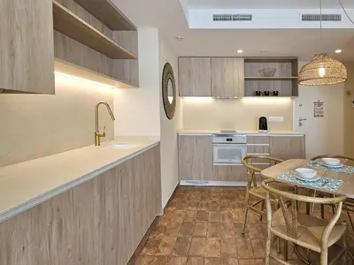 a kitchen and dining room with a table and chairs at Apartamentos Las Ciencias Ñ in Valencia