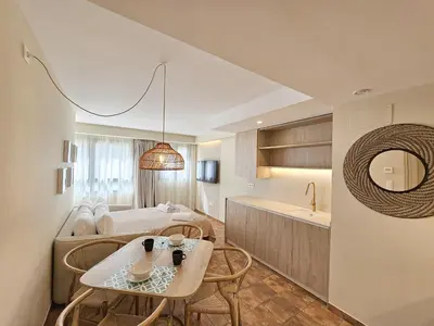 a room with a bed and a table and a kitchen at Apartamentos Las Ciencias Ñ in Valencia