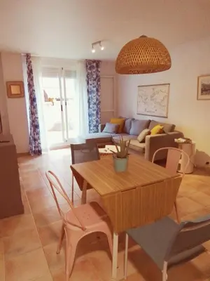 a living room with a table and a couch at Apartamento Analema con piscina wifi y aire acondicionado in Moncófar