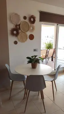 a dining room with a white table and chairs at Playa de Canet, gran Terraza in Valencia