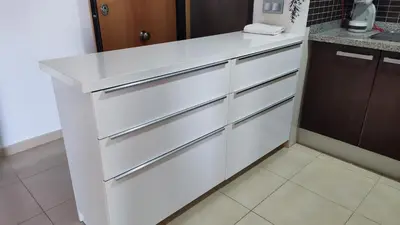 a kitchen with white drawers and a counter at Playa de Canet, gran Terraza in Valencia