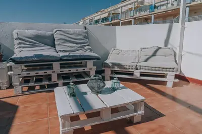 a balcony with two beds and a table on a building at Vivienda Turística Sunbeach-Xilxes VT-42192-CS in Xilxes