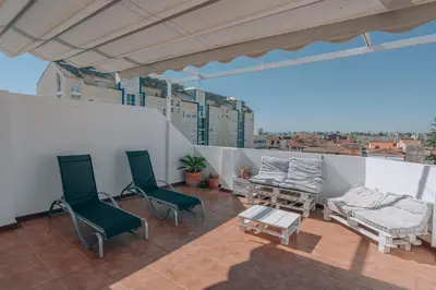 a balcony with two chairs and a couch and a table at Vivienda Turística Sunbeach-Xilxes VT-42192-CS in Xilxes
