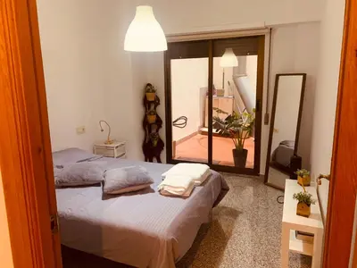 a bedroom with a bed and a large mirror at Valencia Aparthotel COSMO in Valencia