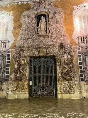 a gate in a building with a statue on it at Valencia Aparthotel COSMO in Valencia