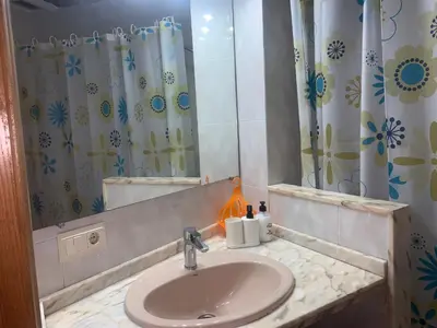 a bathroom with a sink and a shower at Valencia Aparthotel COSMO in Valencia