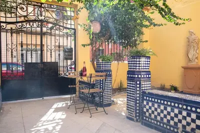 a table and chairs in front of a building at 4 - Acogedora habitación junto a Ruzafa con baño privado y aire acondicionado in Valencia