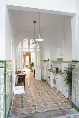 a large kitchen with a table and a chair in it at 4 - Acogedora habitación junto a Ruzafa con baño privado y aire acondicionado in Valencia