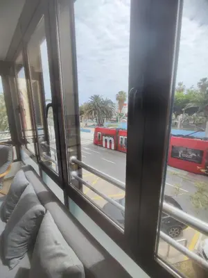 a window of a bus with a view of a street at Bright loft near the sea + BIKES in Valencia