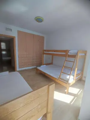 a room with two bunk beds and a ladder at Close to the sea, large (170 m2) apartment+BIKES in Valencia