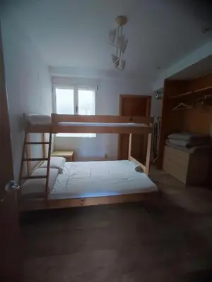 a bedroom with two bunk beds and a window at Close to the sea, large (170 m2) apartment+BIKES in Valencia
