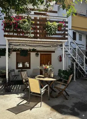 a patio with a table and chairs in front of a building at Cozy apartamento en Ruzafa para 2-3 personas con aire acondicionado y salida directa a terraza in Valencia