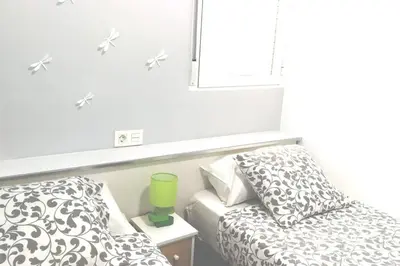 a small bedroom with a bed and a window at Oceanográfico, Playa, Puerto Juanjo in Valencia