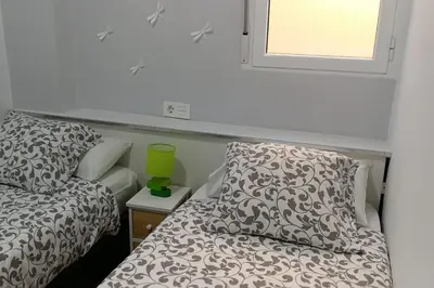 a bedroom with a bed and a pillow and a window at Oceanográfico, Playa, Puerto Juanjo in Valencia