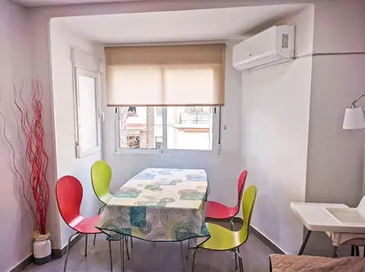 a dining room with a table and four chairs at Oceanográfico, Playa, Puerto Juanjo in Valencia