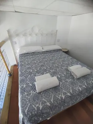 a bedroom with a bed with two pillows on it at Loft duplex industrial near the sea + bicicles in Valencia