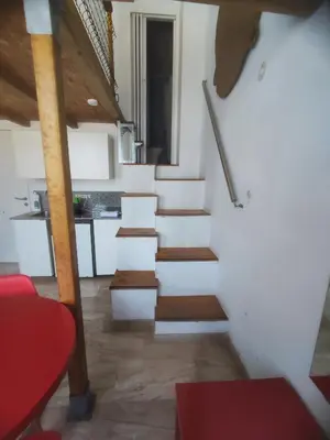 a staircase in a room with white walls and wooden floors at Loft duplex industrial near the sea + bicicles in Valencia