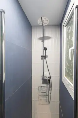 a shower in a bathroom with a blue wall at La casita de pescadores by Concept Flats in Valencia