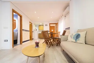 a living room with a couch and a table at La casita de pescadores by Concept Flats in Valencia