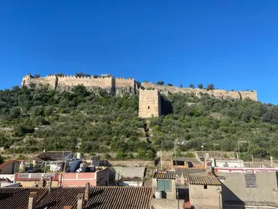 a castle on top of a hill with houses at Casa con jacuzzi y piscina con vistas al castillo in Corbera de Alcira