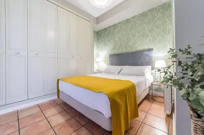 a bedroom with a bed with a yellow blanket on it at Palacio de Rojas by Moontels in Valencia