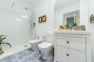 a white bathroom with a toilet and a shower at Palacio de Rojas by Moontels in Valencia