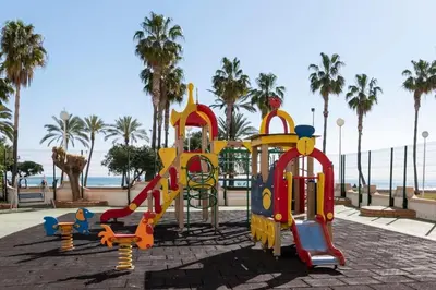 a playground at the beach with palm trees at Florazar I frente a la playa in Cullera