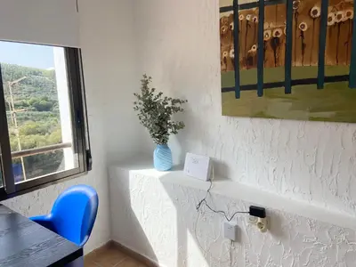 a room with a vase of flowers on a table at Remote Work in Spanish Mediterranean Countryside in Vall de Almonacid