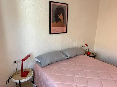 a bedroom with a pink bed and a picture on the wall at Remote Work in Spanish Mediterranean Countryside in Vall de Almonacid