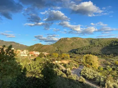 a road in the middle of a valley with mountains at Remote Work in Spanish Mediterranean Countryside in Vall de Almonacid
