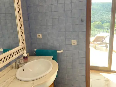 a bathroom with a white sink and a balcony at Remote Work in Spanish Mediterranean Countryside in Vall de Almonacid