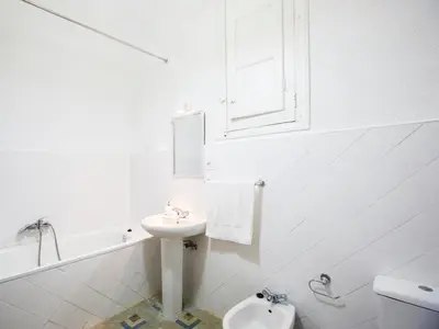 a white bathroom with a sink and a toilet at Total Valencia Terrace in Valencia