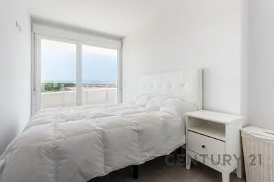 a white bedroom with a bed and a window at Luxury Apartment with 2 Bedrooms in Canet d'en Berenguer, Valencia in Canet de Berenguer