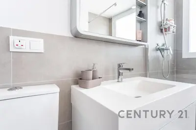 a bathroom with a white sink and a mirror at Luxury Apartment with 2 Bedrooms in Canet d'en Berenguer, Valencia in Canet de Berenguer