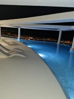 a view of the pool on a cruise ship at night at Luxury Apartment with 2 Bedrooms in Canet d'en Berenguer, Valencia in Canet de Berenguer