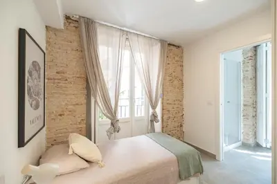 a bedroom with a bed and a large window at Residencia Universitaria Trinitarios in Valencia