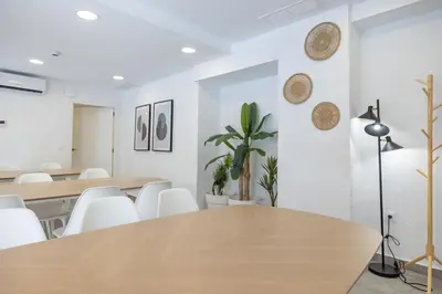 a dining room with a table and white chairs at Residencia Universitaria Trinitarios in Valencia