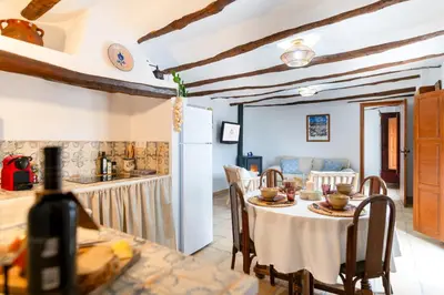 a kitchen and dining room with a table and chairs at Casa Rural La Corretger in Chulilla