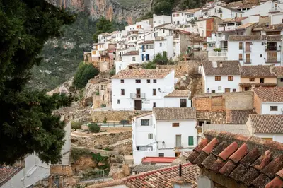 a village on a hillside with white houses at Casa Rural La Corretger in Chulilla