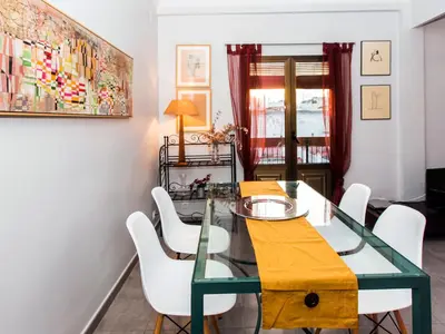 a dining room with a glass table and white chairs at Total Valencia El Carmen (Leisure & Culture) in Valencia