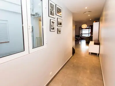 a hallway with a white wall with pictures at Total Valencia El Carmen (Leisure & Culture) in Valencia