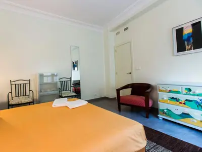 a bedroom with a large orange bed and two chairs at Total Valencia El Carmen (Leisure & Culture) in Valencia