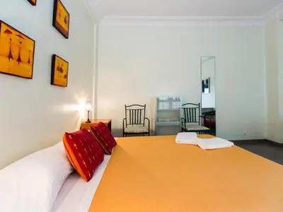 a bedroom with a large bed with red pillows at Total Valencia El Carmen (Leisure & Culture) in Valencia