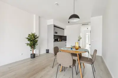 a dining room and kitchen with a table and chairs at Limehome Valencia Calle de Cadiz in Valencia
