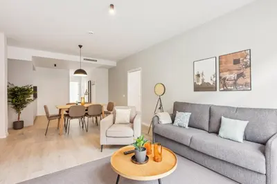 a living room with a couch and a table at Limehome Valencia Calle de Cadiz in Valencia