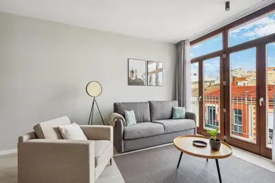 a living room with a couch and a table at Limehome Valencia Calle de Cadiz in Valencia