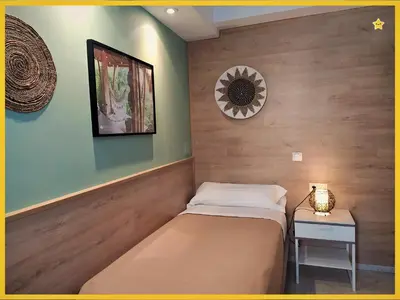 a bedroom with a bed and a table and a mirror at Habitaciones Barra89 in Valencia