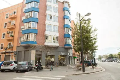 a tall building on the corner of a street at Habitaciones Barra89 in Valencia