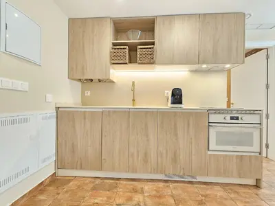 a kitchen with wooden cabinets and a stove at Apartamentos Las Ciencias Studio P in Valencia