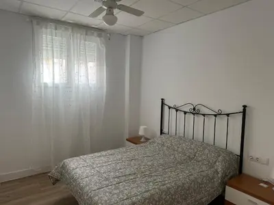 a bedroom with a bed and a ceiling fan at Apartamento Valencia 17 in Paiporta